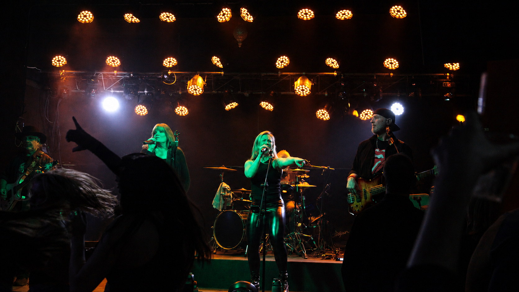 Drama Queen performing under stage lights