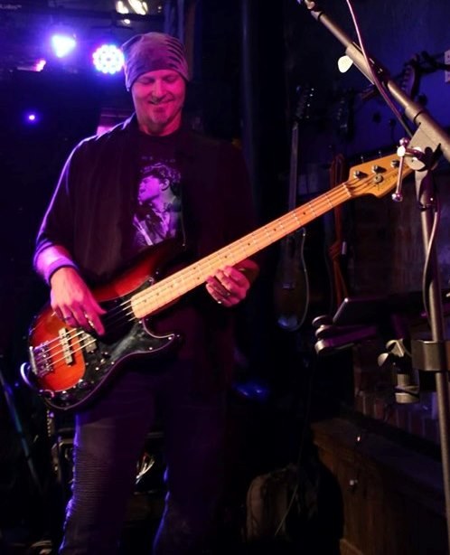 TK performing under purple lights